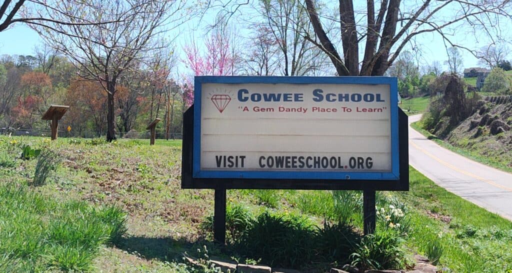 Cowee School sign promoting community learning and activities.