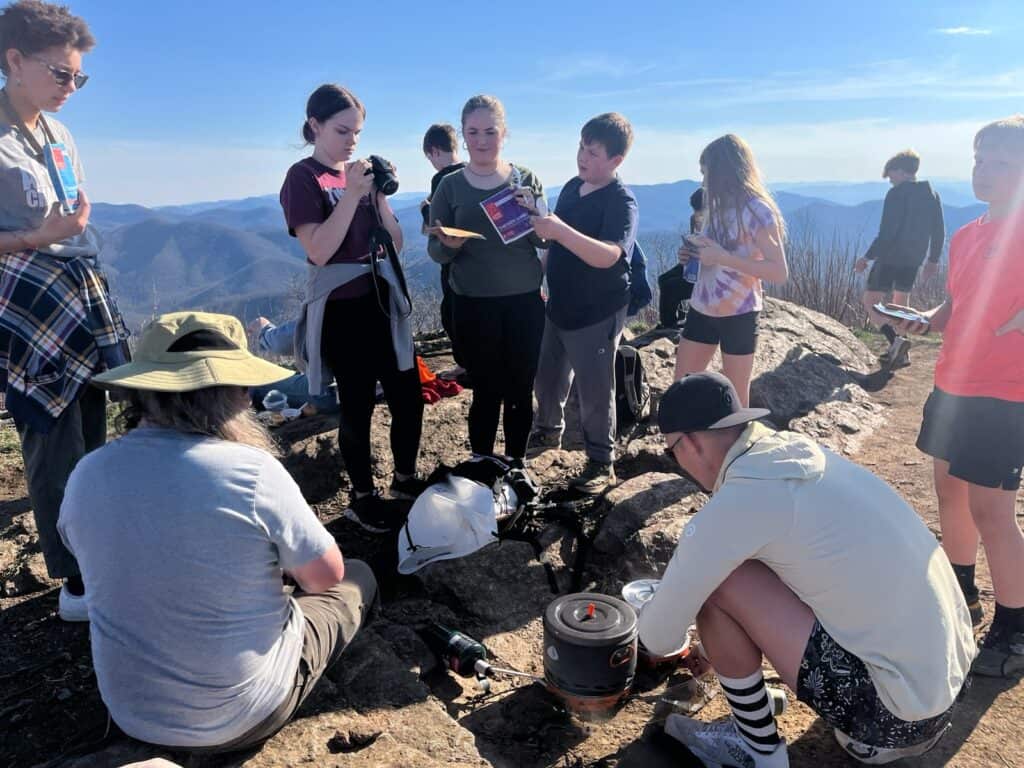 Group of students learning about hiking and trail respect outdoors.