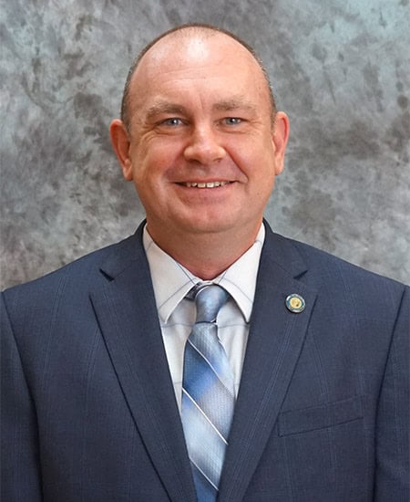 Guffey, in a suit, announces his candidacy for mayor in Guffey's campaign event.