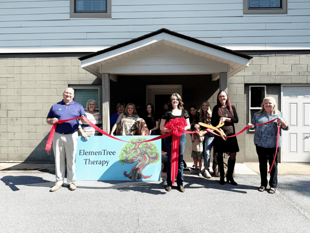 Group of people at ribbon-cutting ceremony outside a building for Macon Sense.