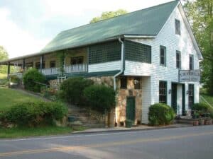 Historic building with green roof and white siding in Macon, Georgia.