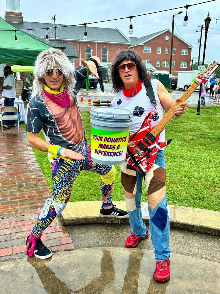 People dressed in vibrant 80s costumes at charity event.