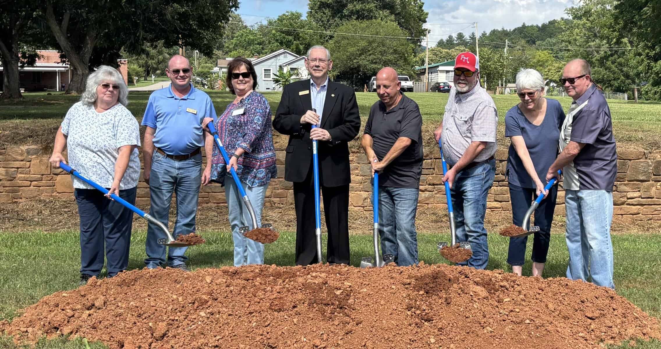 Ground breaking on new playground represents a kept promise to the town