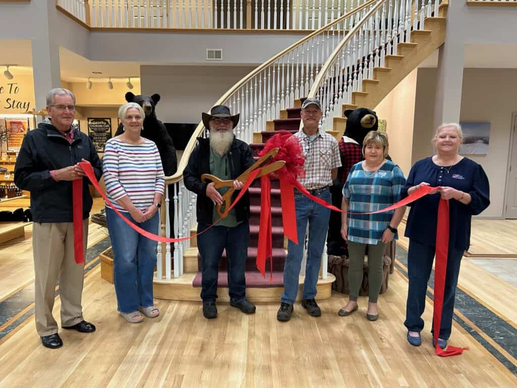 Local business leaders celebrate new members at ribbon-cutting event.