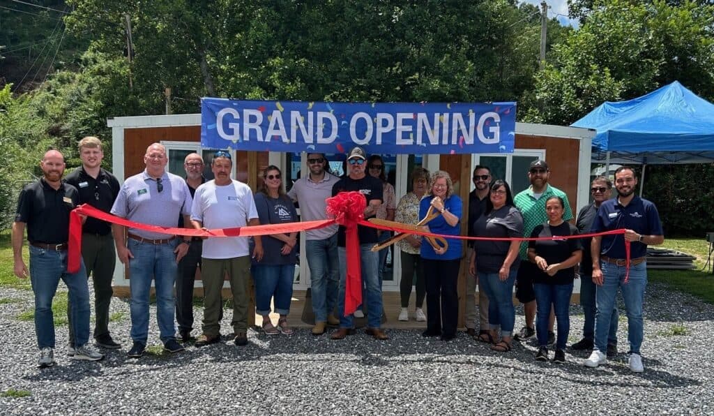 Group of new business members at grand opening event in Macon Sense.