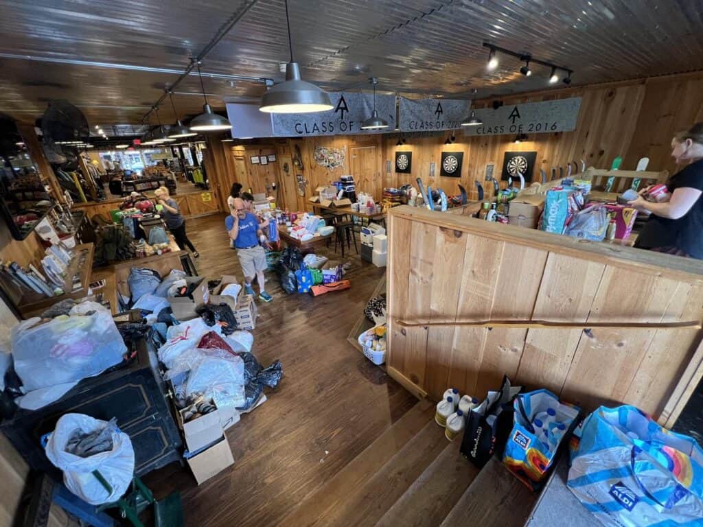 Community volunteers organizing donations at Macon Sense for Helene's anniversary.