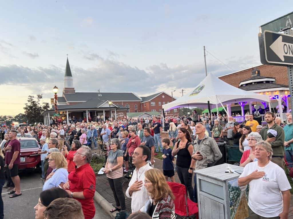 Crowd gathered in Macon for prayer event, community unity in action.