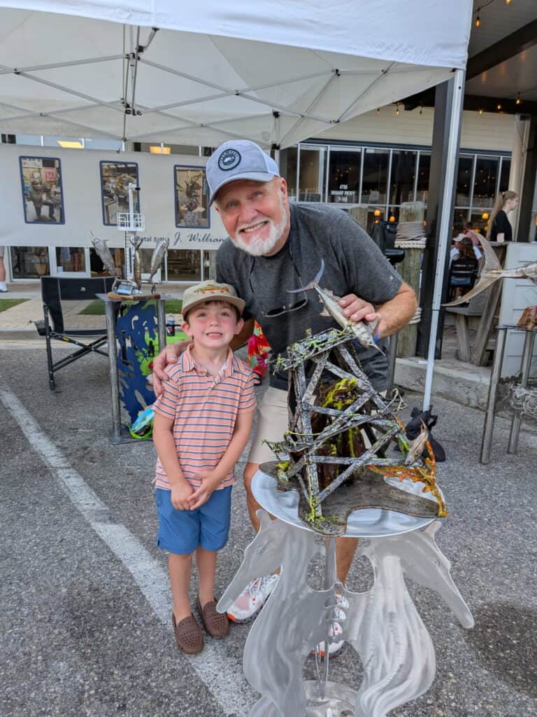 Franklin showcasing his artistic metal sculpture at Macon arts event.