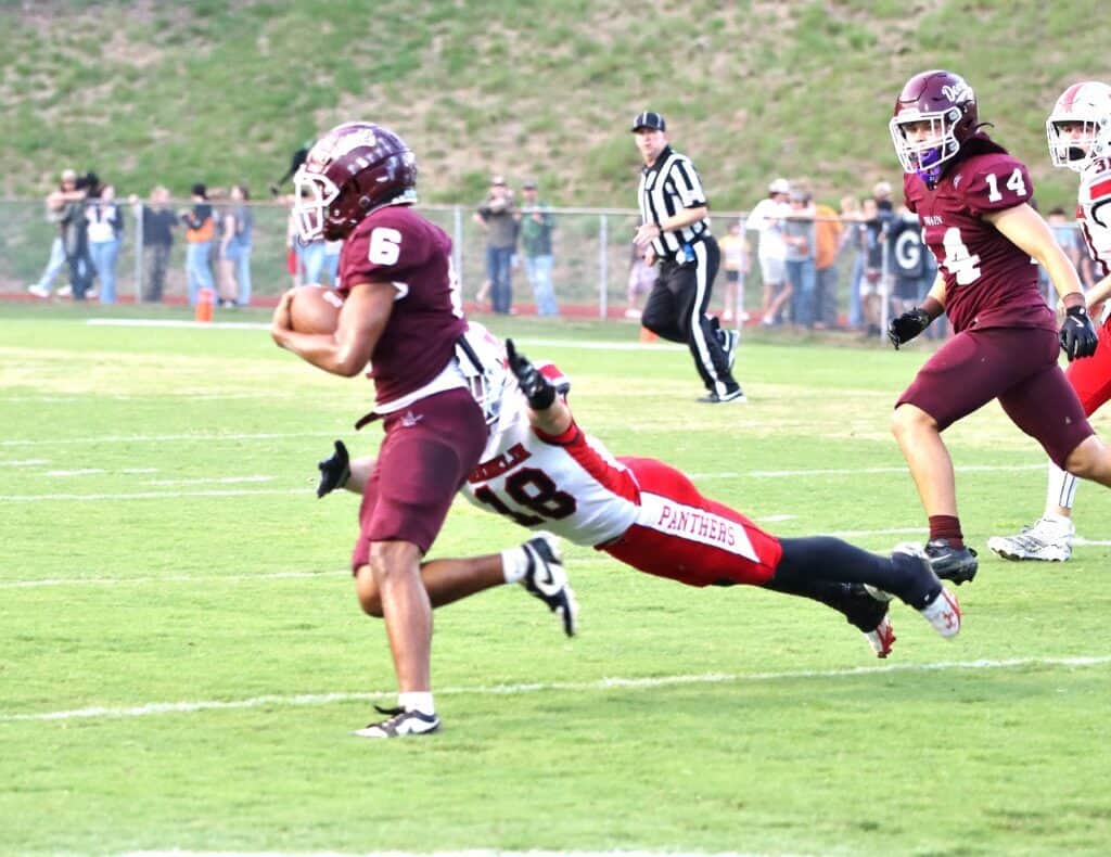 FHS Panthers football game with players in action on the field.