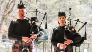 Two musicians playing bagpipes outdoors for Macon Sense events.