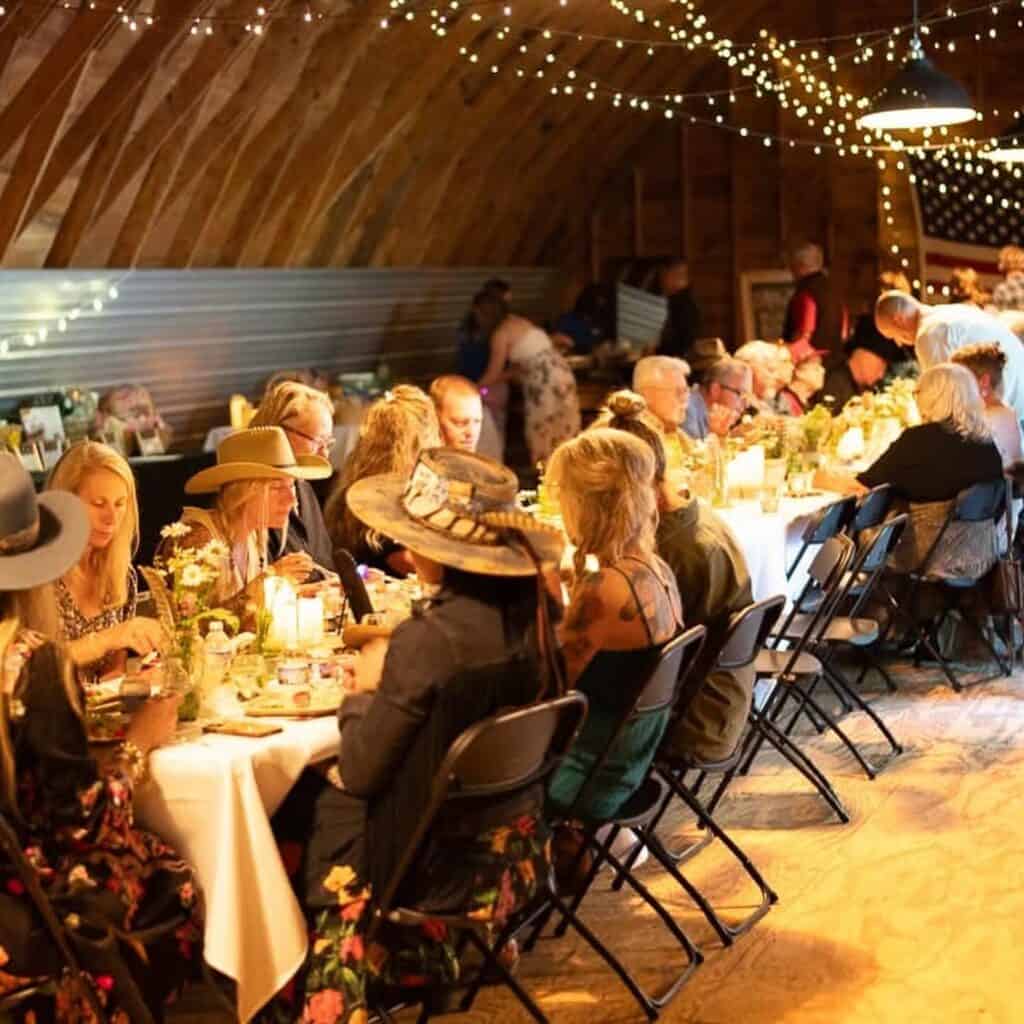 An elegant farm dinner under lights.