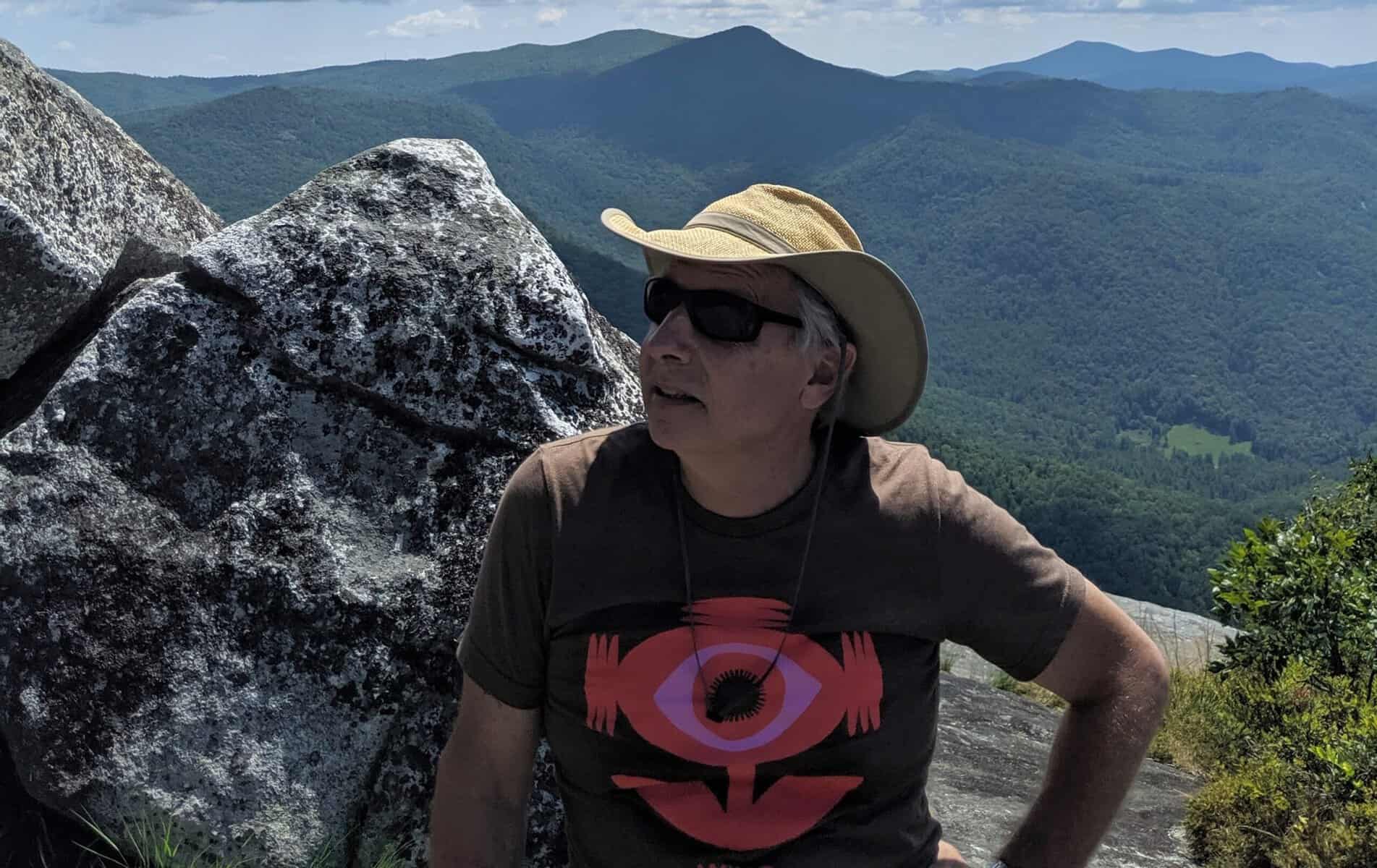 Retiring Bartram Trail leader enjoying mountain views in outdoor gear.