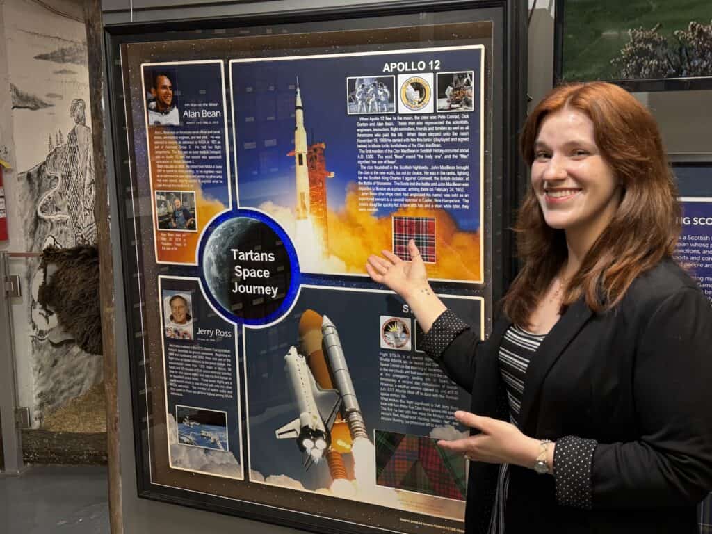 Scottish Tartan Museum curator presenting space exploration exhibit.