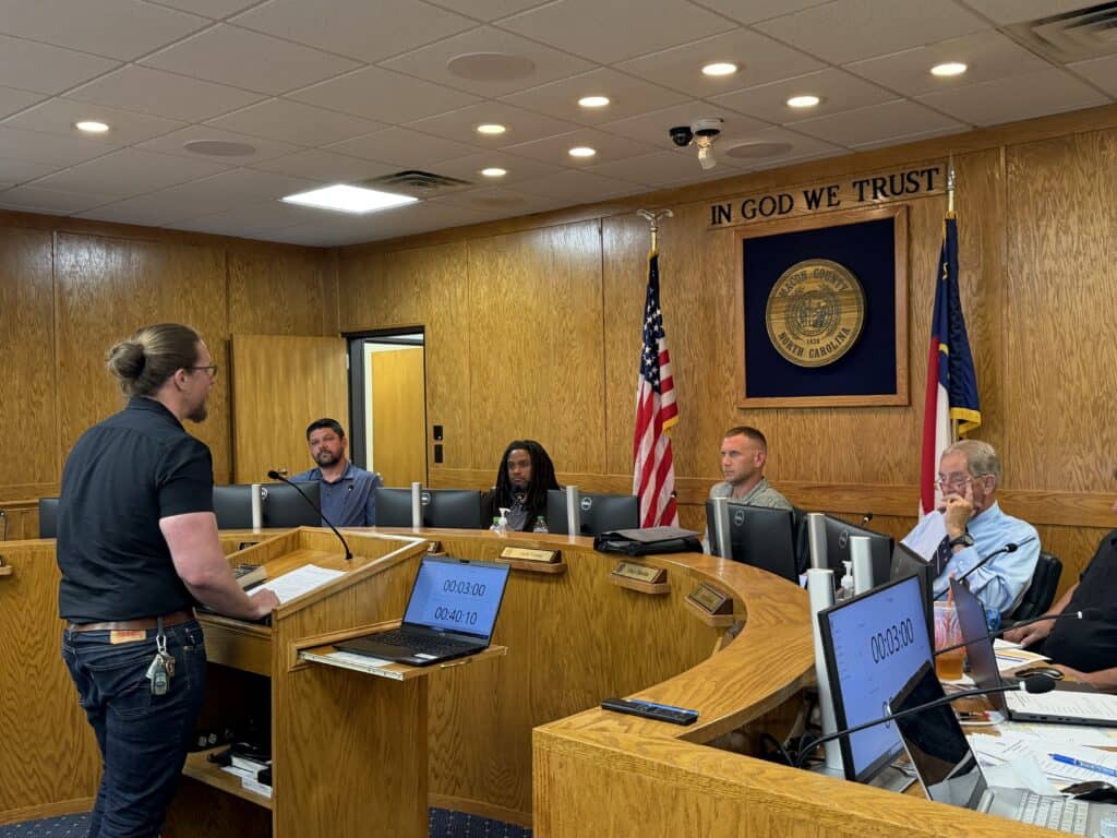 City council meeting with diverse members discussing policies.