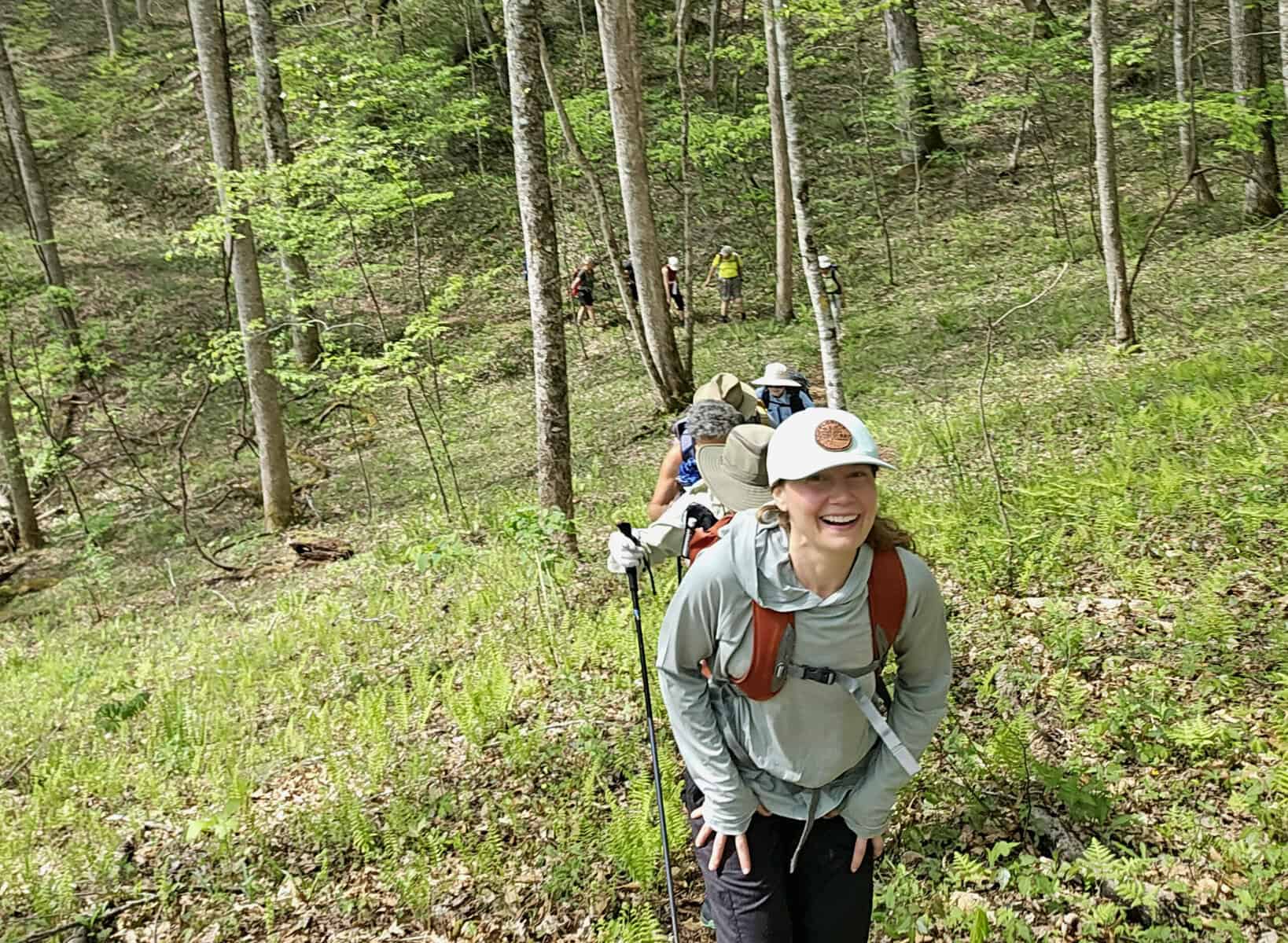 Hikers exploring the Bartram Trail in lush green woods under new leadership.