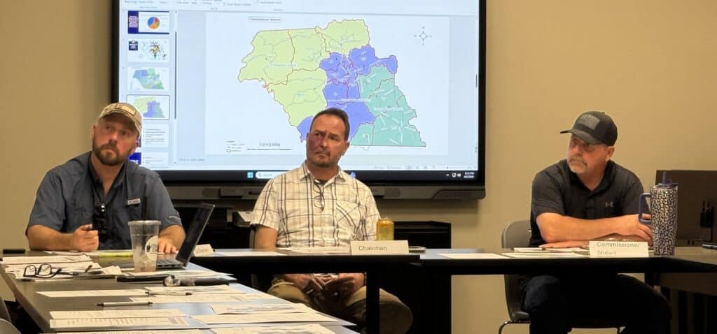 Planning board discussing redistricting maps and strategies.