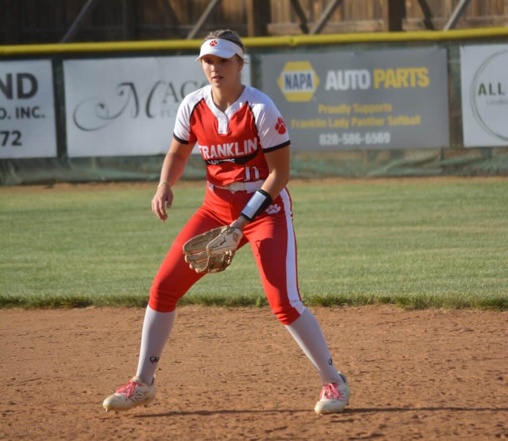 Softball player from FHS in a game, ready to catch the ball during conference playoffs.