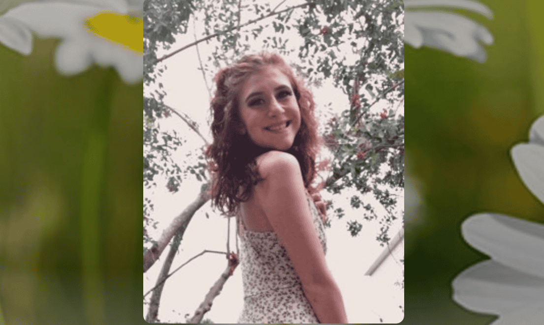 Ashley Marie Vasallo smiling outdoors in natural light.