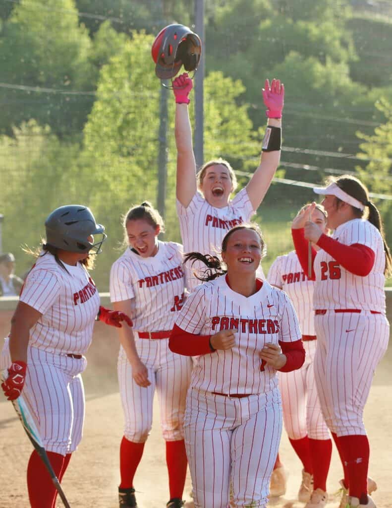 FHS softball team celebrating after a game, showing team spirit and excitement.
