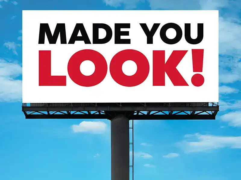 Billboard with bold "Made You Look" message against a blue sky background.
