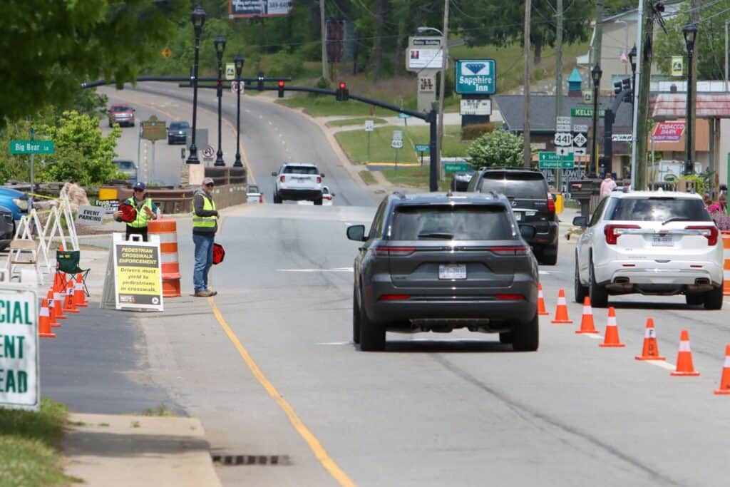 Roadblock with traffic cones and officials during spring festival in Macon, Georgia.