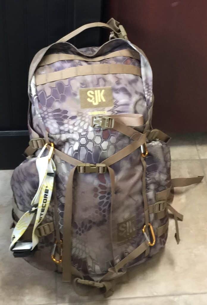 Durable Macon Sense backpack with snake skin pattern, ideal for outdoor activities and travel.