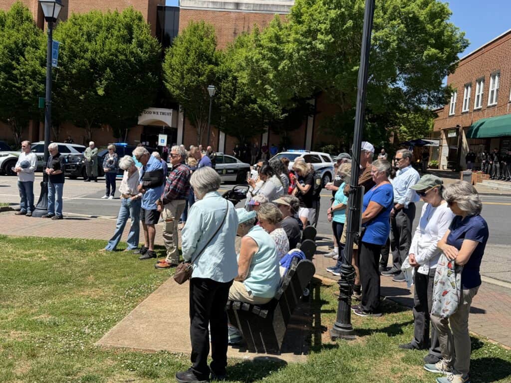 Macon community event with people waiting outdoors in downtown Macon, Georgia.