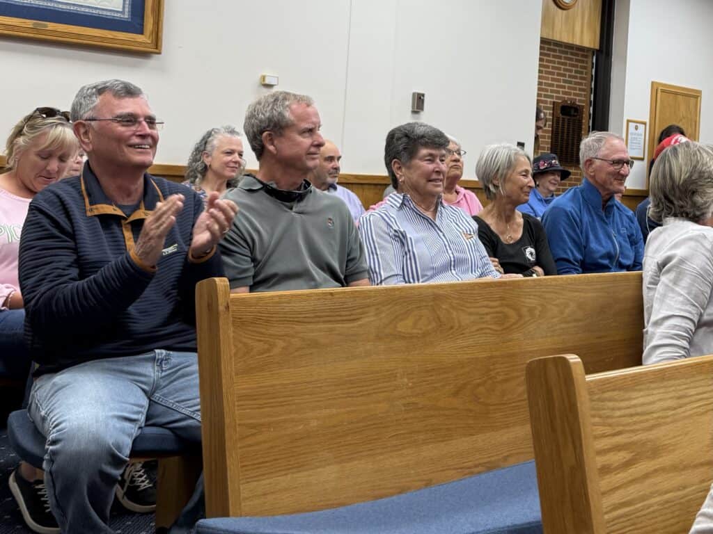 Happy seniors attending a community event in a church setting.