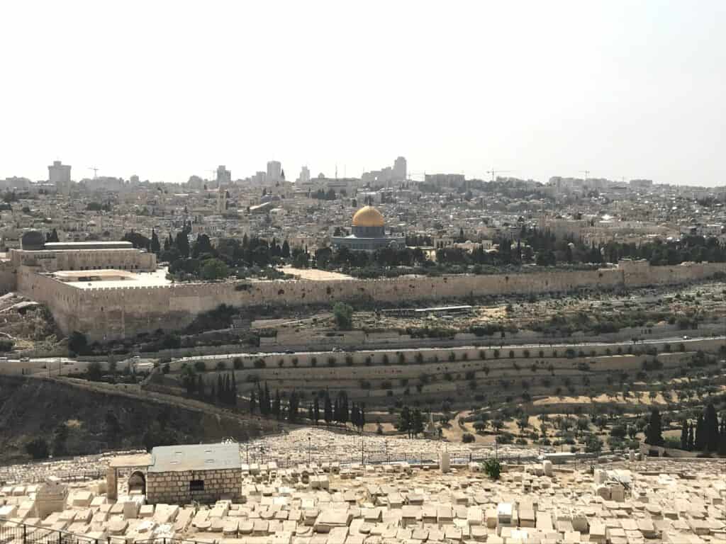 A panoramic view of Jerusalem's skyline featuring the Dome of the Rock and historic cityscape.