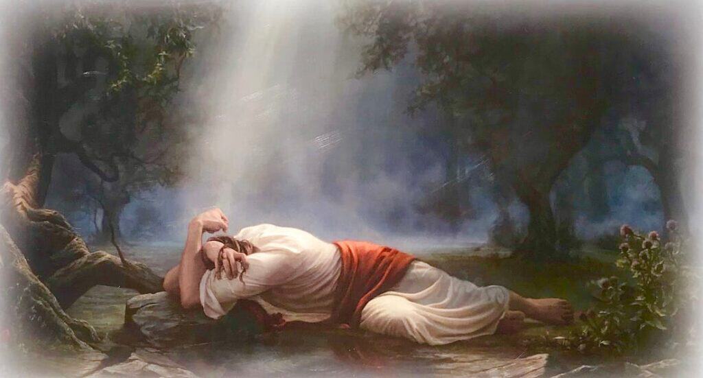 Classical Jesus Christ lying on the ground in a serene forest scene.