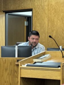 Man in courtroom during legal proceeding at Macon Sense.