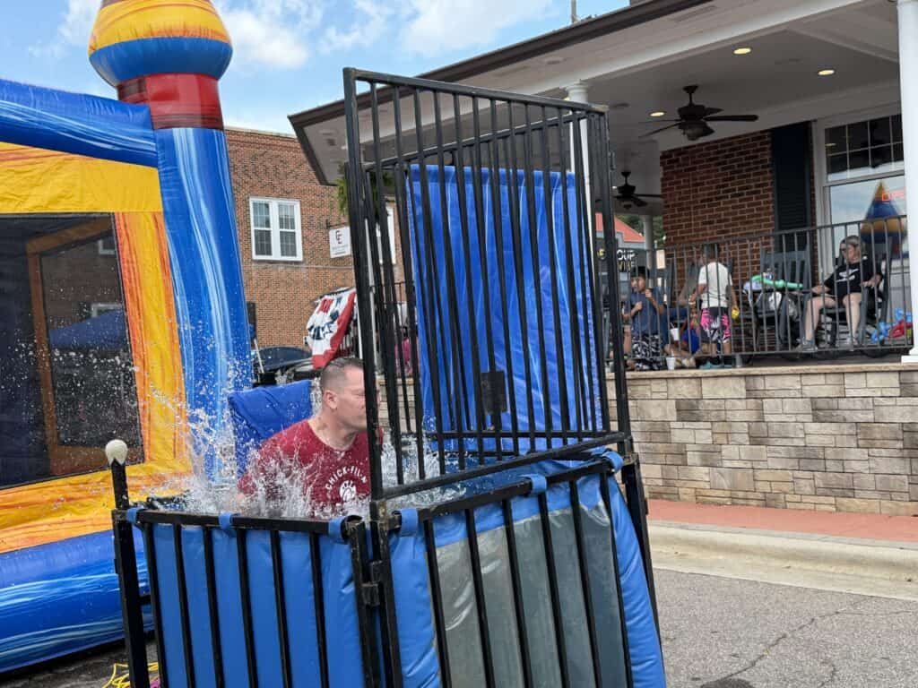 Child playing on water slide during Family Fun Day event.