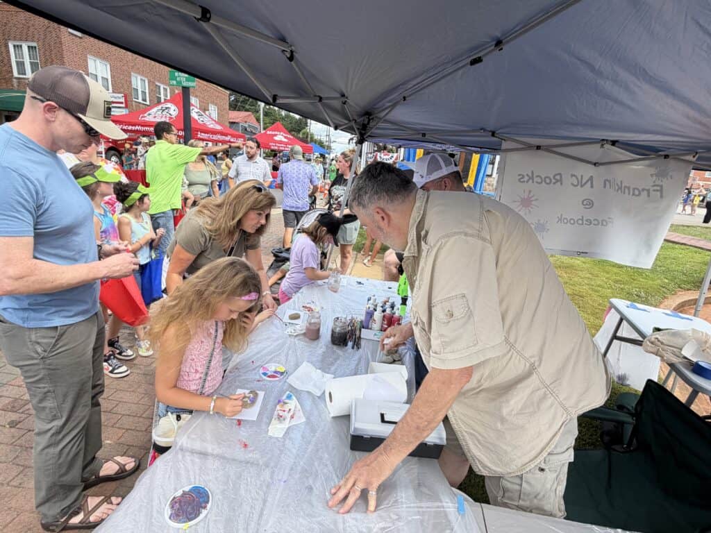 People participating in a community event at Macon Sense with children and adults.