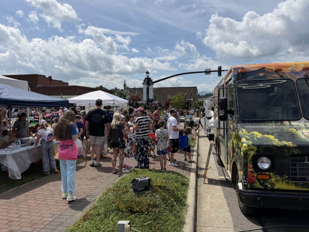 Crowd enjoying Family Fun Day with food trucks and vendors in downtown Macon.