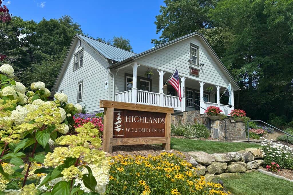 Charming Highlands Welcome Center with white house and garden.