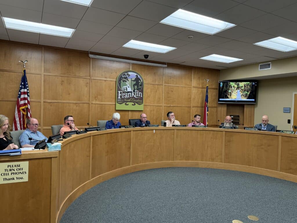 City council members seated at a curved table during a meeting in Franklin.
