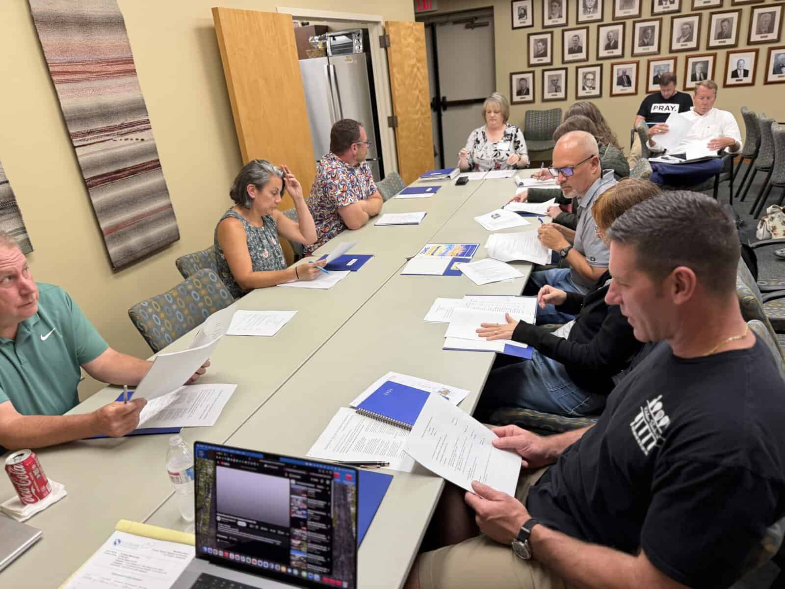 Business meeting with diverse professionals around a conference table.