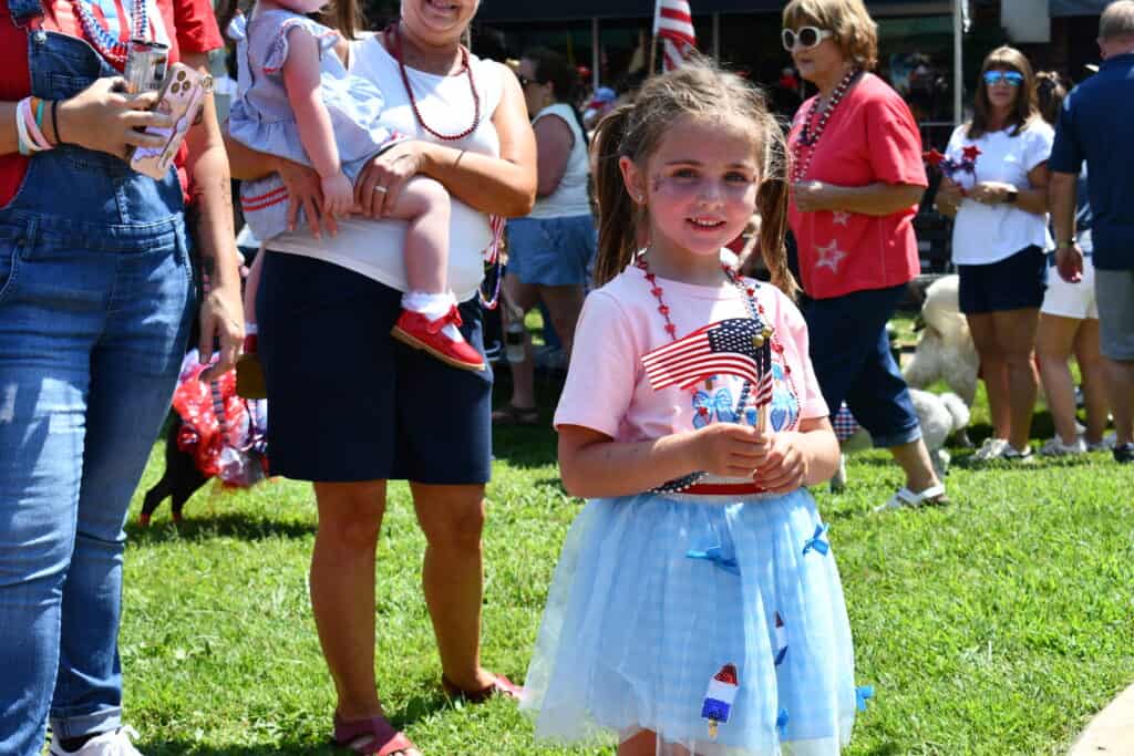 Young girl holding American flag during 4th of July celebration in Franklin.