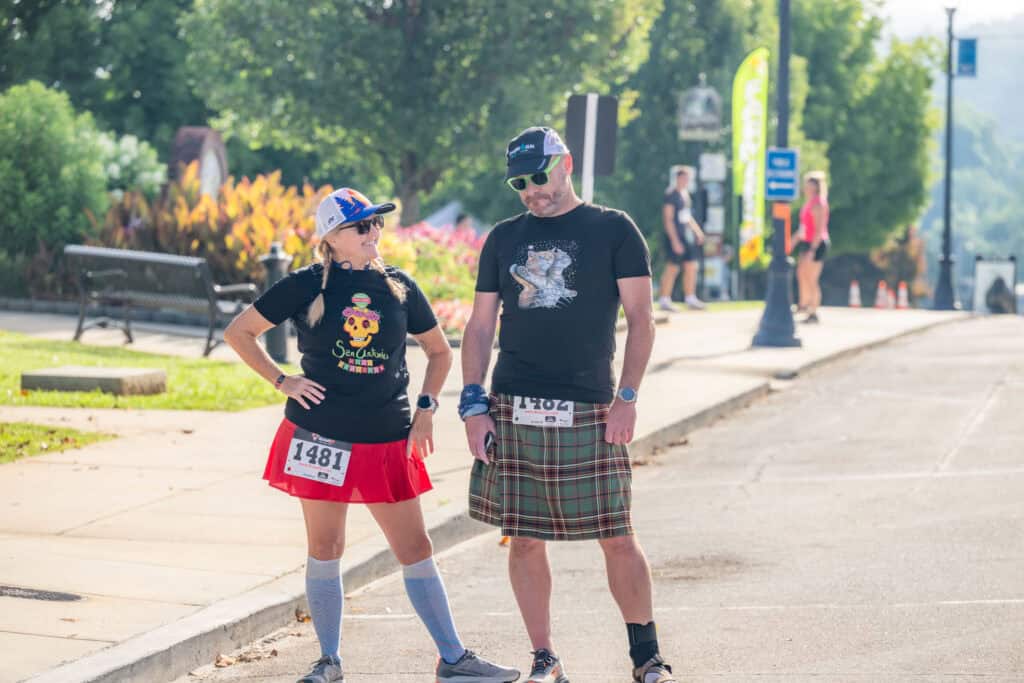 Participants in running event wearing tartan kilts and race bibs at Franklin's own Tartan Army.