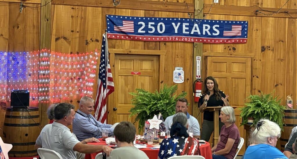 GOP event celebrating 250 years with speakers and attendees in a decorated hall.