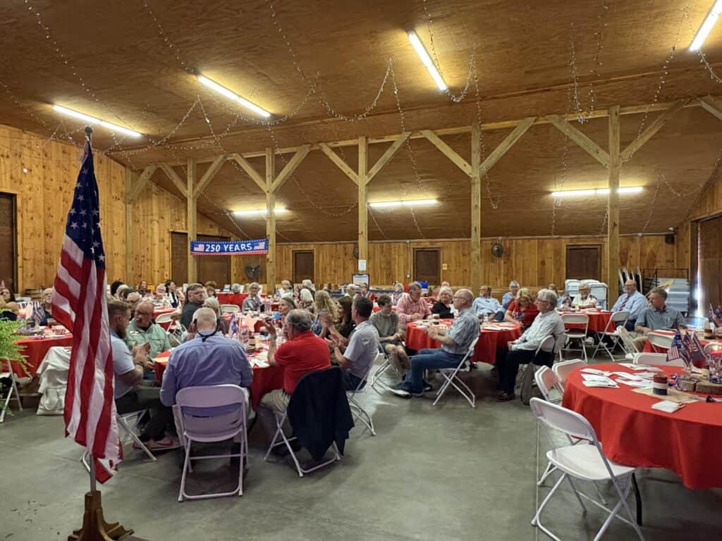 Macon County GOP gathering during campaign season in a wooden hall.
