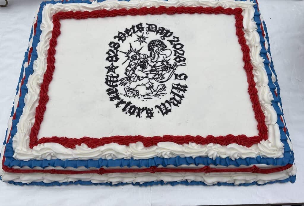 Large rectangular cake with patriotic colors and a logo for 828 Vets celebration.