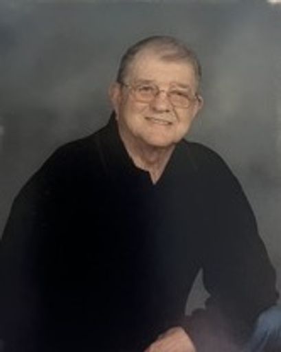 Portrait of George Lugar Hendrickson, elderly man with glasses and a black shirt.