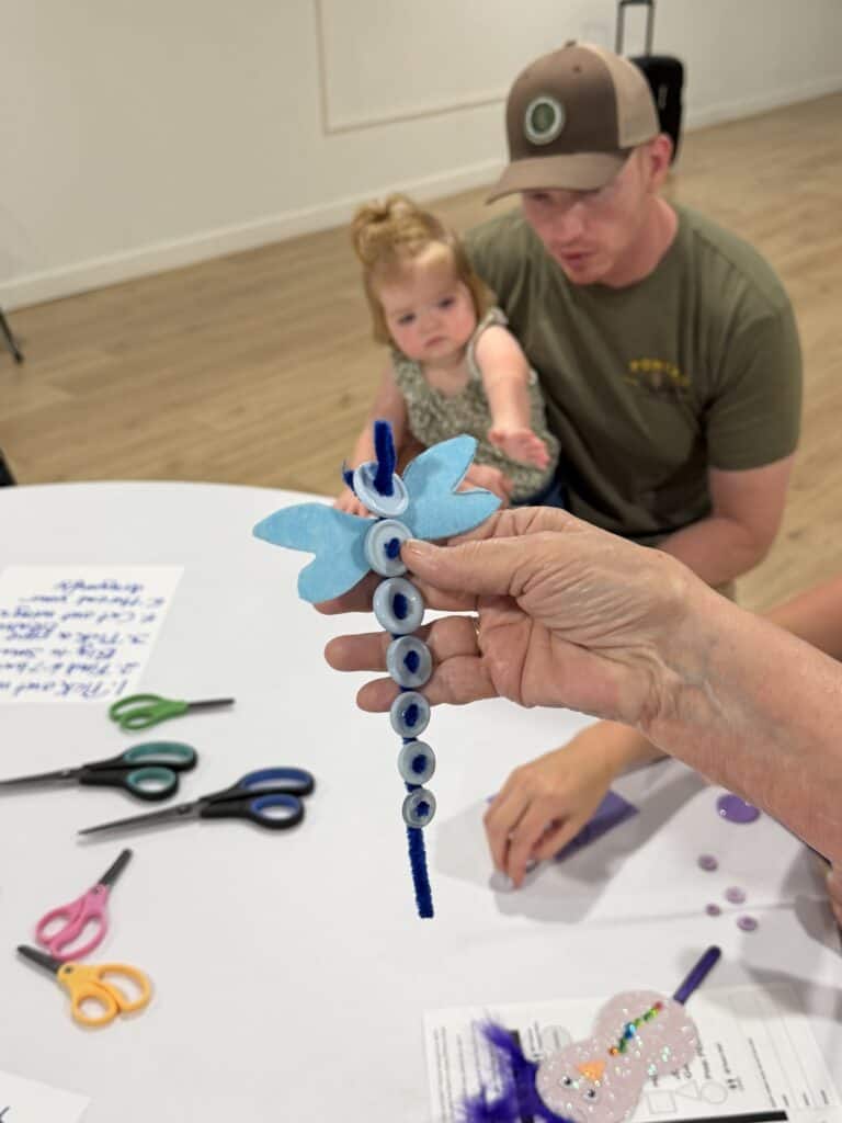 Child and adult creating a colorful felt unicorn craft project.