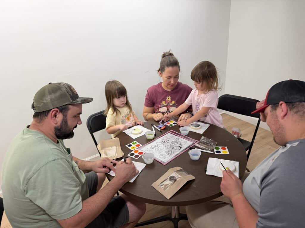 Family painting activity with children and adults at Macon Sense.