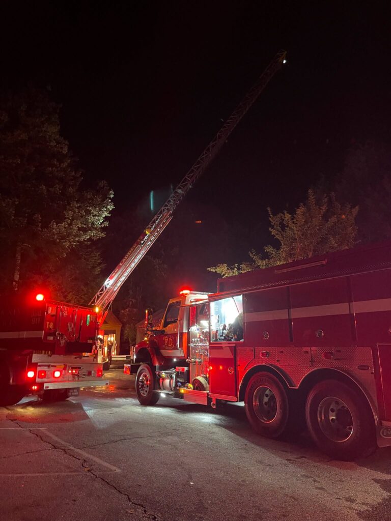 Fire trucks and ladder at night during a fire emergency at Macon Sense.