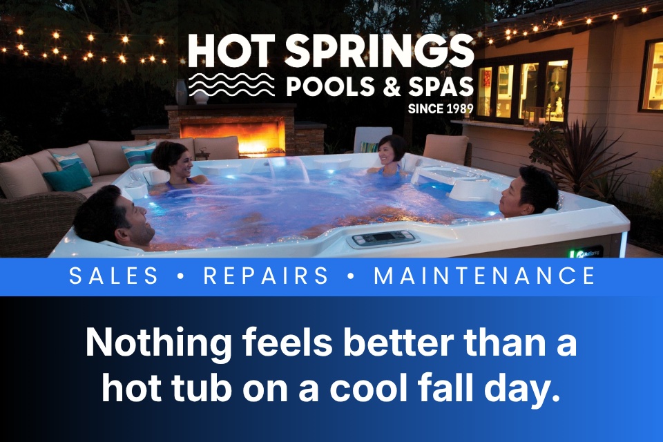 Hot Springs Pools & Spas hot tub on a cool fall day with people relaxing.