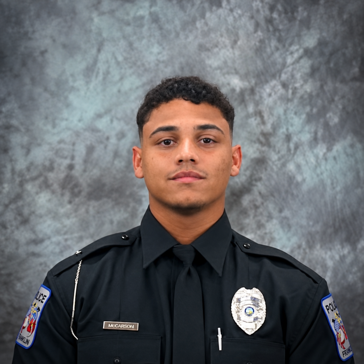Young police officer in uniform during a formal event or ceremony.