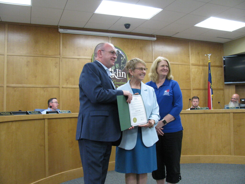 Franklin council members during a formal meeting with a certificate presentation.