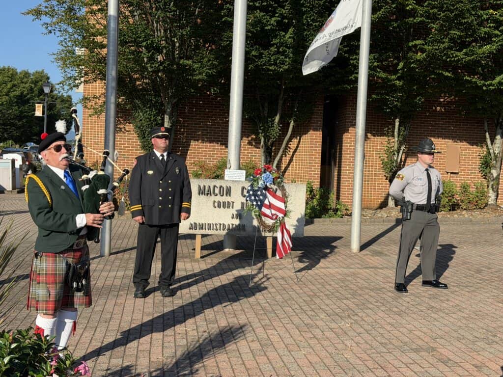 Memorial ceremony with veterans and flags in Macon County.